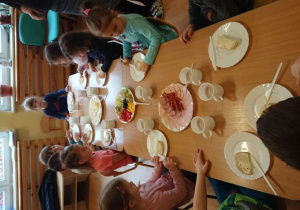dzieci jedzą wspólnie śniadanie