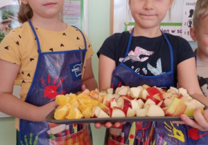 dzieci trzymają tace z owocami