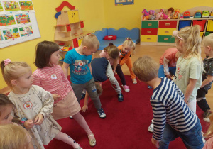 dzieci wykonyją ćwiczenie gimnastyczne