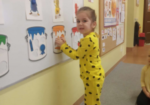 Dziewczynka nakleja magnesy.