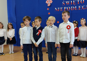 Chłopcy na scenie recytują wiersz.