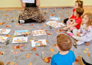 Pani pokazuje dzieciom plansze.