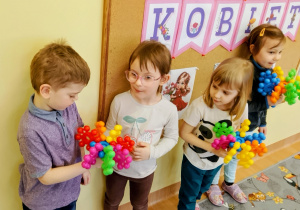 Chłopiec wręcza dziewczynce zabawkowego kwiatka.
