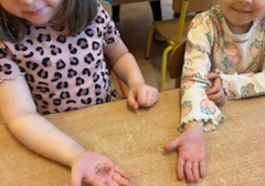 Dziewczynki pokazują ręce z brokatem.